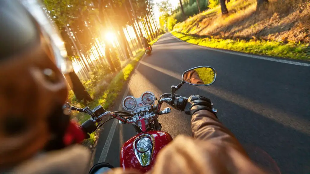 Why should you visually check for motorcycles when changing lanes